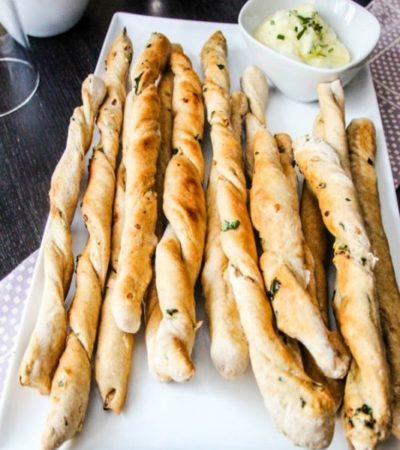 Garlic & Kale Breadsticks with Honey Herb Butter- These homemade breadsticks are baked with flavorful ingredients and topped with a delicious herb butter.