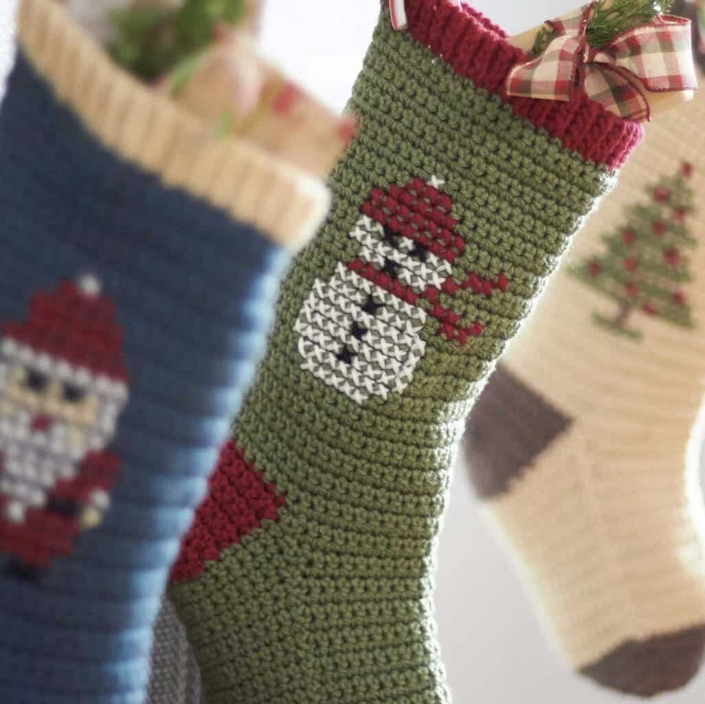 beautiful cross-stitch crochet stockings showing three different designs