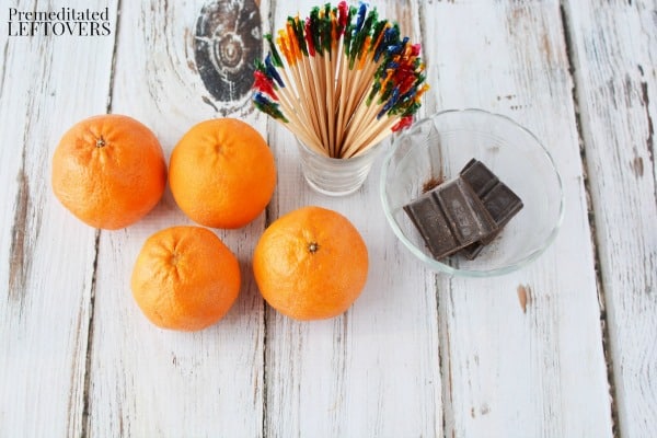 Items needed to make chocolate dipped orange hearts: clementines, chocolate, and toothpicks