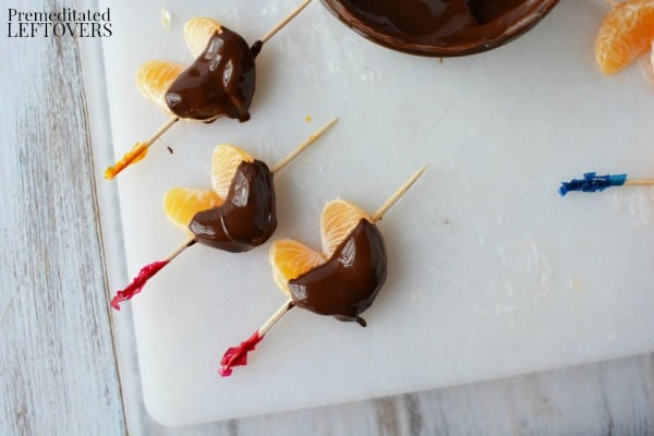 Chocolate Dipped Clementine Hearts sitting while the melted chocolate hardens.