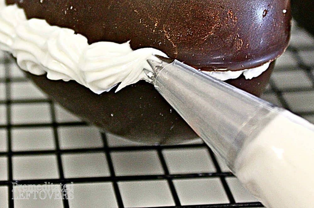 Pipe royal icing around the seam on the hollow chocolate eggs