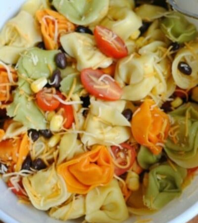 Gently stir the ingredients for the Southwest Ranch Tortellini Salad recipe