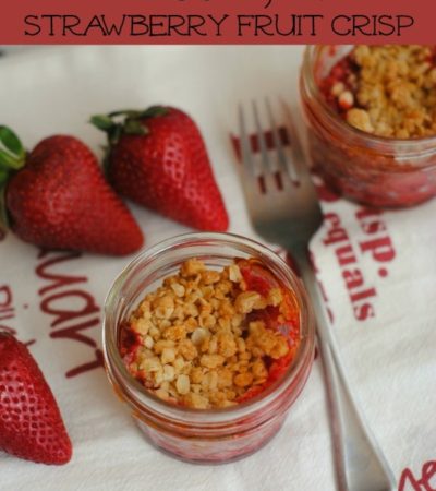Mason Jar Strawberry Fruit Crisp Recipe- Enjoy this delightful strawberry crisp straight from the oven. Baking it in mason jars creates perfect portions.