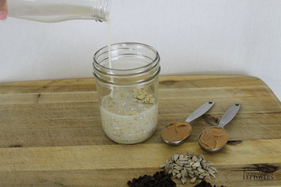 Peanut Butter Trail Mix Refrigerator Oatmeal - adding almond milk to oats