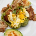 Stuffed Breakfast Peppers- Use leftovers to make this delicious breakfast recipe. Green peppers are loaded with eggs, veggies, potatoes, and chicken.