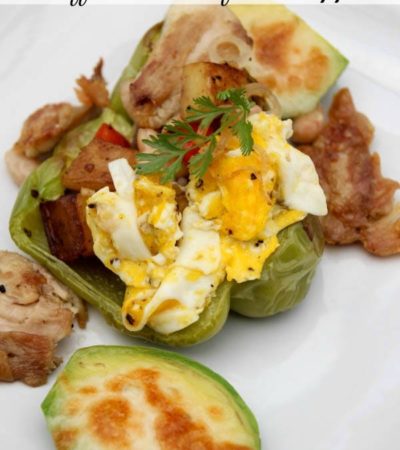 Stuffed Breakfast Peppers- Use leftovers to make this delicious breakfast recipe. Green peppers are loaded with eggs, veggies, potatoes, and chicken.