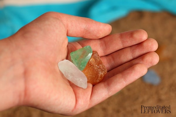 child holding pieces of sea glass