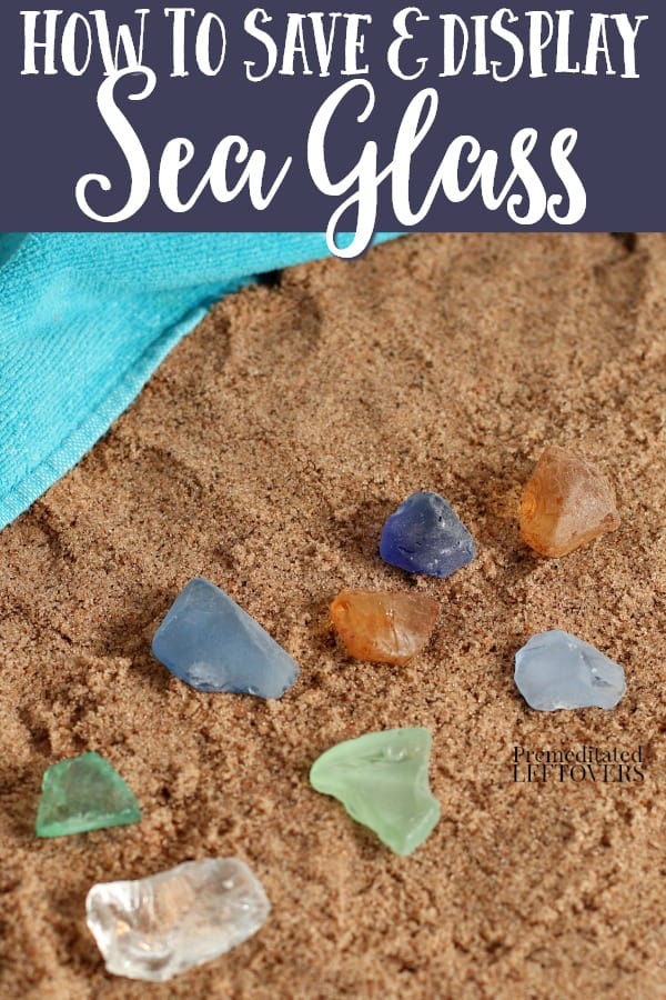 pieces of colored sea glass sitting on sand
