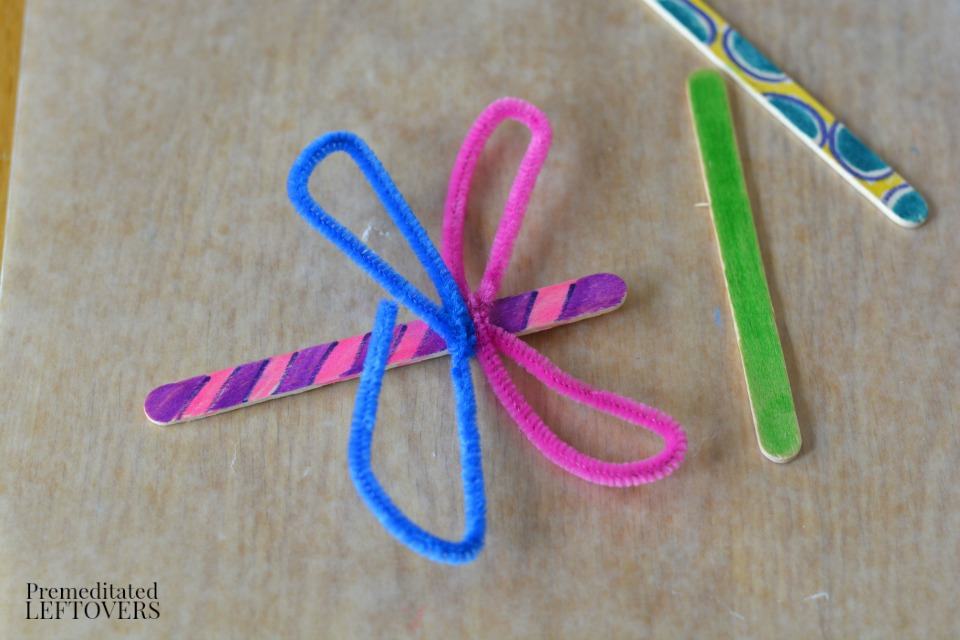 Popsicle Stick Dragonfly Craft with Buttons - fold pipe cleaner twice to make second wing
