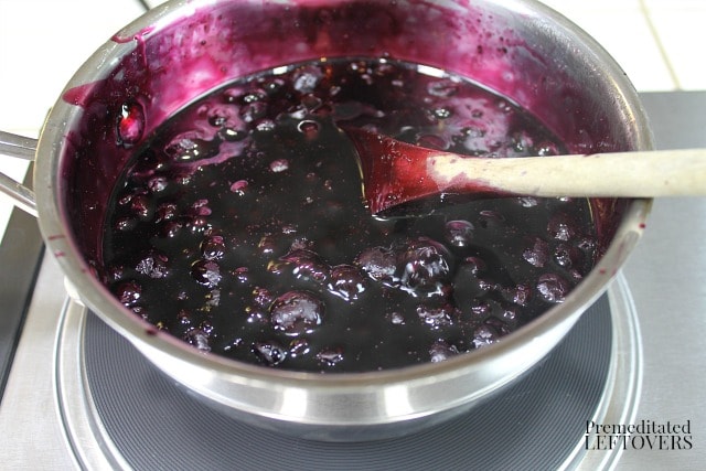 Simmer blueberry syrup until it thickens