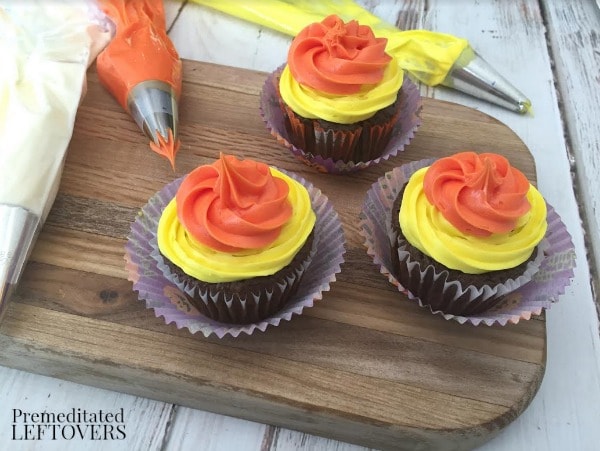 Easy Candy Corn Cupcakes- layering candy corn colored frosting