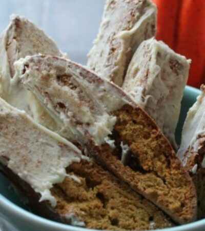 A tasty homemade Pumpkin Gingerbread Biscotti Recipe. This pumpkin biscotti includes all of the spices and flavors of fall and is dipped in white chocolate.