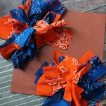 Homemade Pom Poms Tutorial- Create your own pom poms in your favorite team's colors with this easy tutorial. All you need is 10 minutes and $2 in supplies.