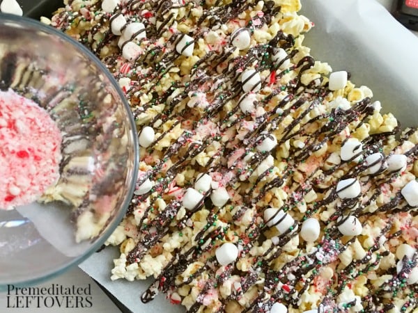 This Peppermint Chocolate Drizzled Popcorn recipe is a delicious holiday treat. Enjoy it with a Christmas movie or package it up for holiday gift bags. 