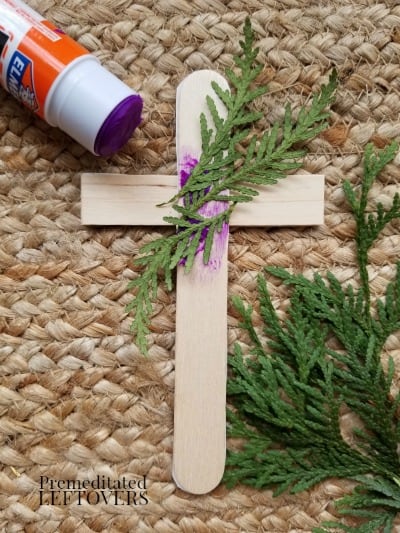 Glue the greenery and twine to the back of the cross.