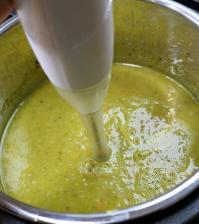 Using an immersion blender to blend the split pea soup after cooking it in an Instant Pot