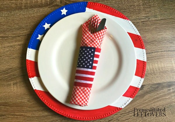 DIY patriotic table decor idea. Place setting includes a flag charger, gingham napkin, and flag napkin ring.