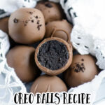 A box of homemade Oreo balls. One Oreo Cookie Ball is cut in half so you can see the truffle like filling.