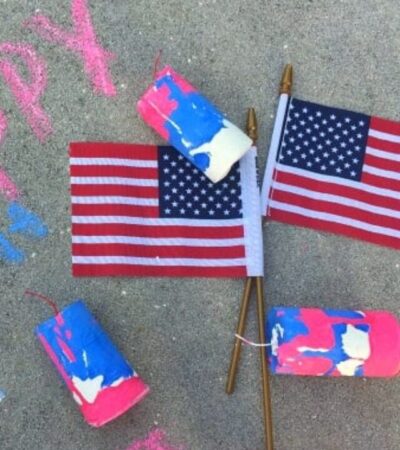 firecracker sidewalk chalk on concrete with chalk writing.