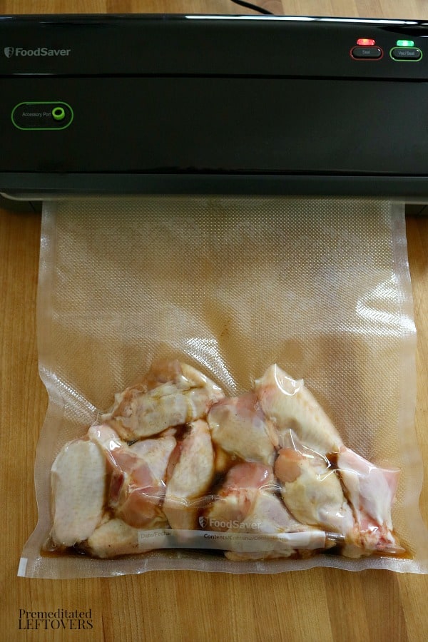 Vacuum sealing chicken wings in a Foodsaver Sous Vide Bag.