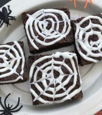 These spider web brownies are an easy Halloween dessert idea. You start with a box of brownie mix to make brownies, then use vanilla frosting and a toothpick to create the spider web on top of the brownies.