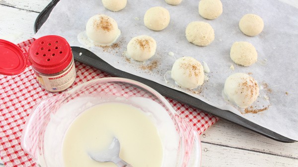 Coat the eggnog truffles in melted white chocolate then sprinkle with nutmeg