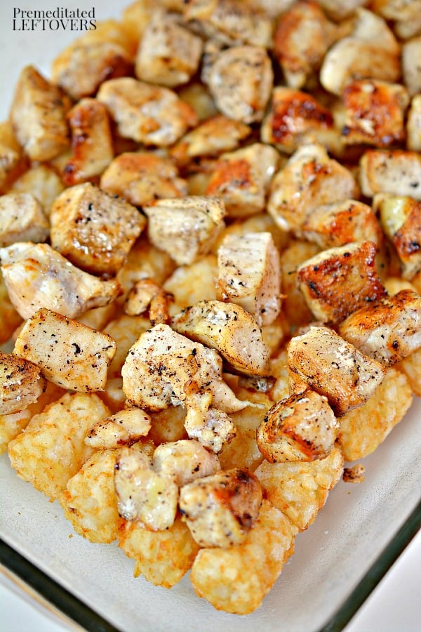 Place the cooked chicken on top of the layer of tater tots