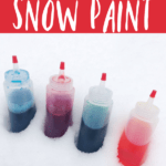 bottles of snow paint sitting in the snow