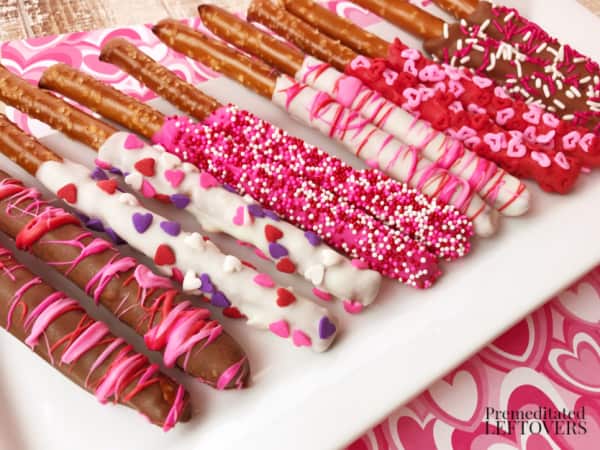 chocolate dipped pretzel rods on plate