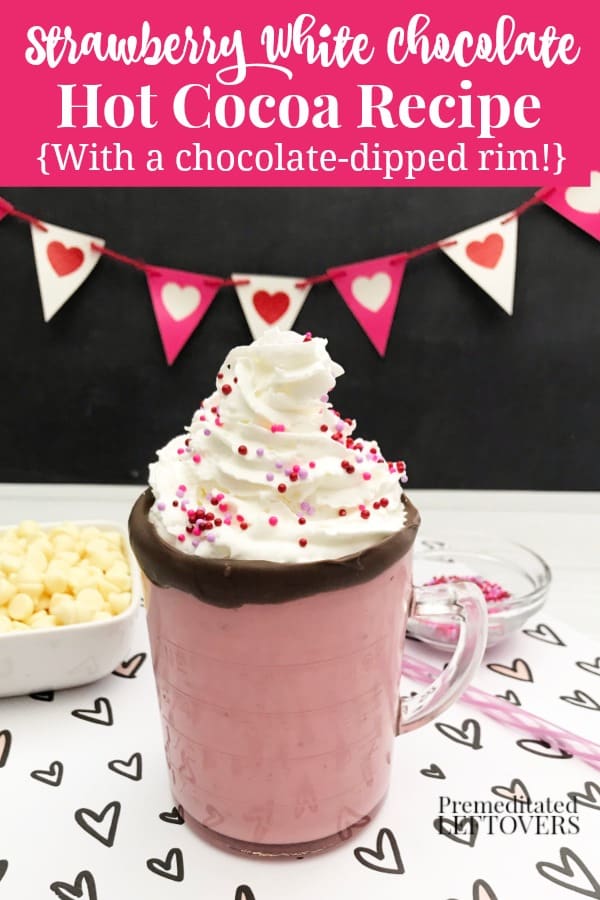 Strawberry White Hot Chocolate Recipe with a chocolate dipped rim on the mug, whipped cream, and Valentine sprinkles