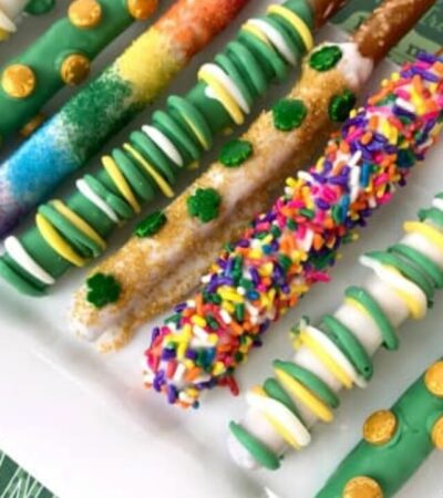 rainbow and green pretzel rods for St. Patrick's Day on a plate