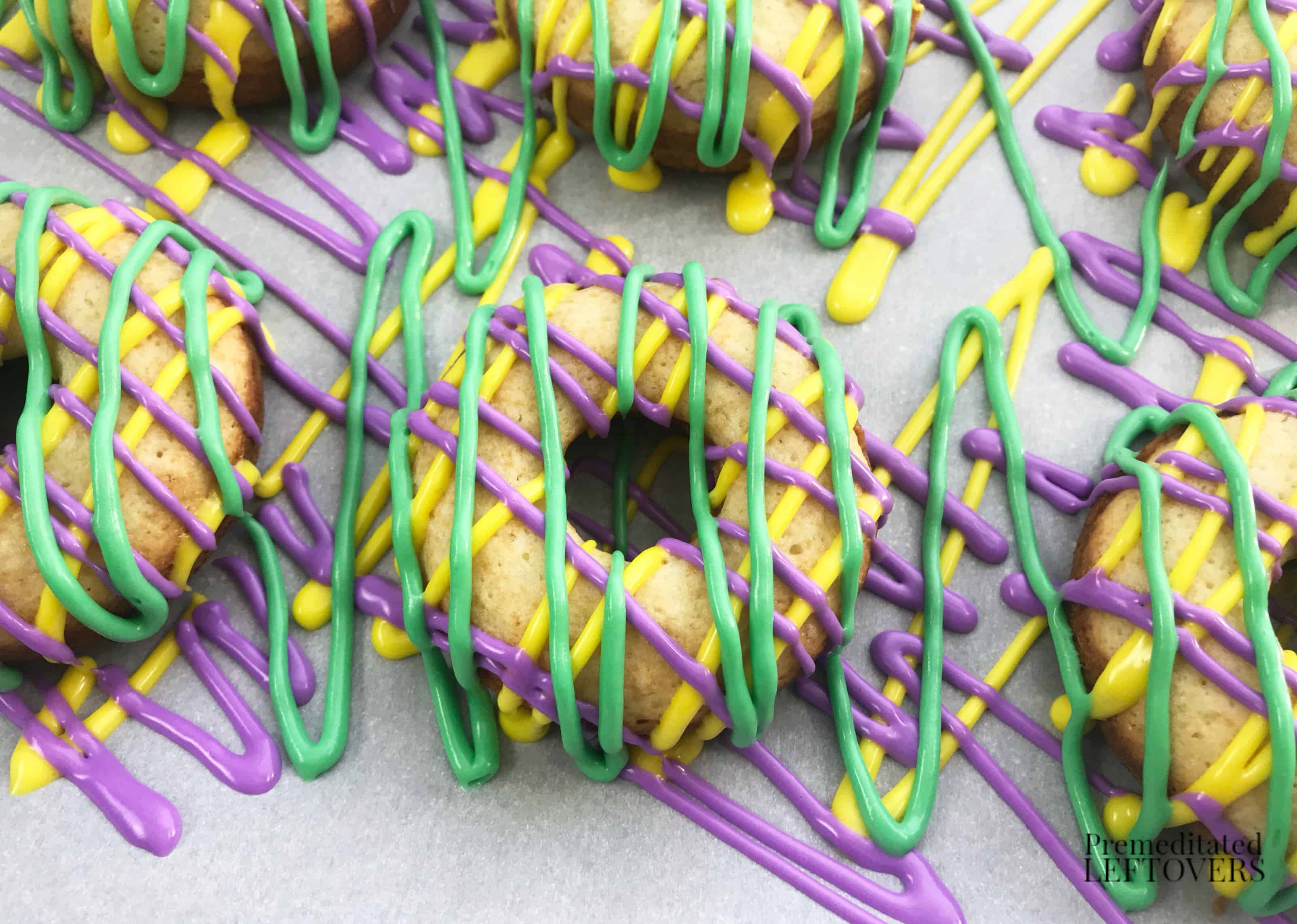 Drizzled icing on King cake donuts