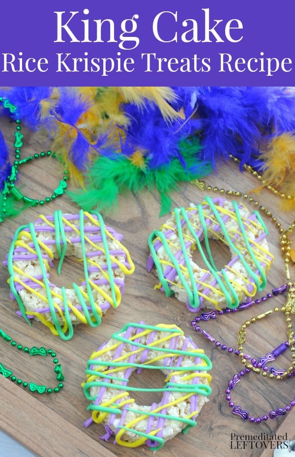 Purple, green and yellow king cake rice krispie treats on a tray with a boa and Mardi Gras beads.