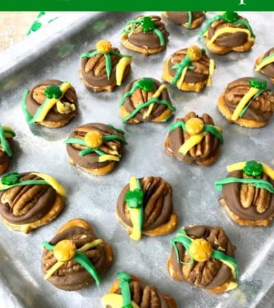 st patricks day pretzel turtles on a silver pan with colored candy drizzle