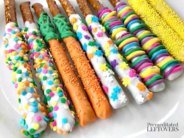 white chocolate covered pretzel rods with easter decorations on plate