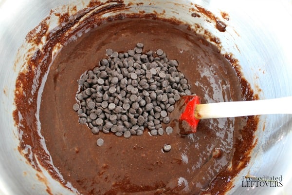 Add chocolate chips to gluten-free chocolate muffin batter.