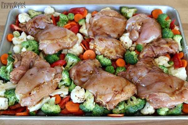 The Mongolian chicken thighs placed on top of the vegetables.