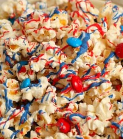 red, white, and blue candy-coated popcorn in a blue bowl