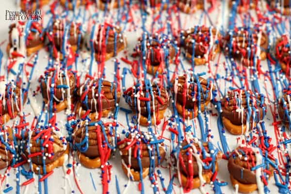 Melted candy coating drizzled over Rolo pretzel turtles and topped with patriotic sprinkles.