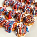 patriotic rolo pretzel turtles topped with red, white, and blue candy melts and sprinkles