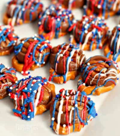 patriotic rolo pretzel turtles topped with red, white, and blue candy melts and sprinkles