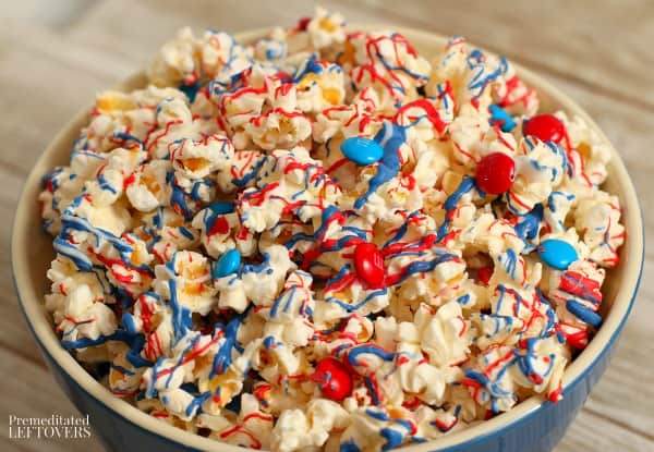 red, white, and blue candy-coated popcorn in a blue bowl