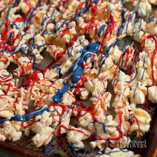 red, white, and blue candy melts drizzled over popcorn
