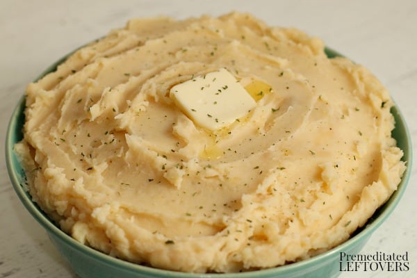 Quick and easy pressure cooker mashed potatoes in a bowl topped with butter.