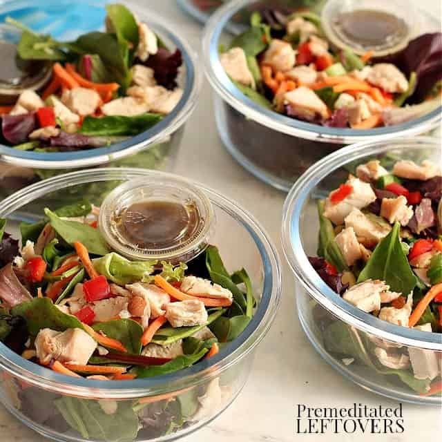Asian chicken salads in meal prep bowls with Asian dressing