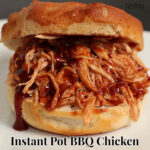 Quick and easy instant pot bbq chicken on a hamburger bun with barbecue sauce dripping off the shredded chicken.