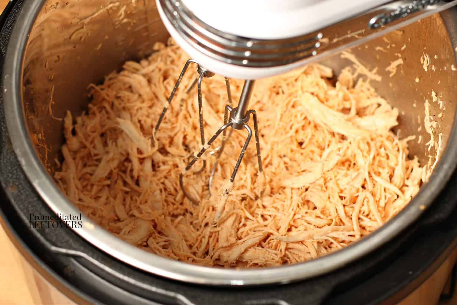 shredding instant pot barbecue chicken with a hand mixer