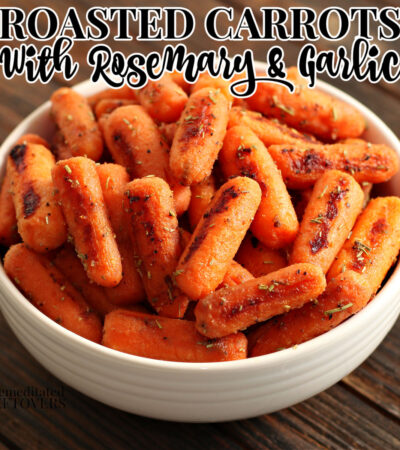 A bowl of roasted carrots with rosemary and garlic