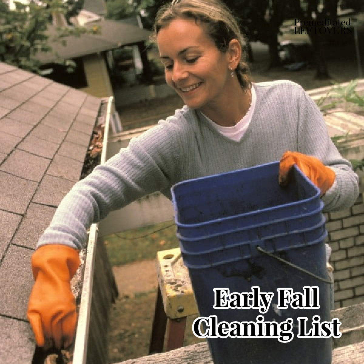 Woman removing leaves from gutter as part of fall cleaning and winter prep.