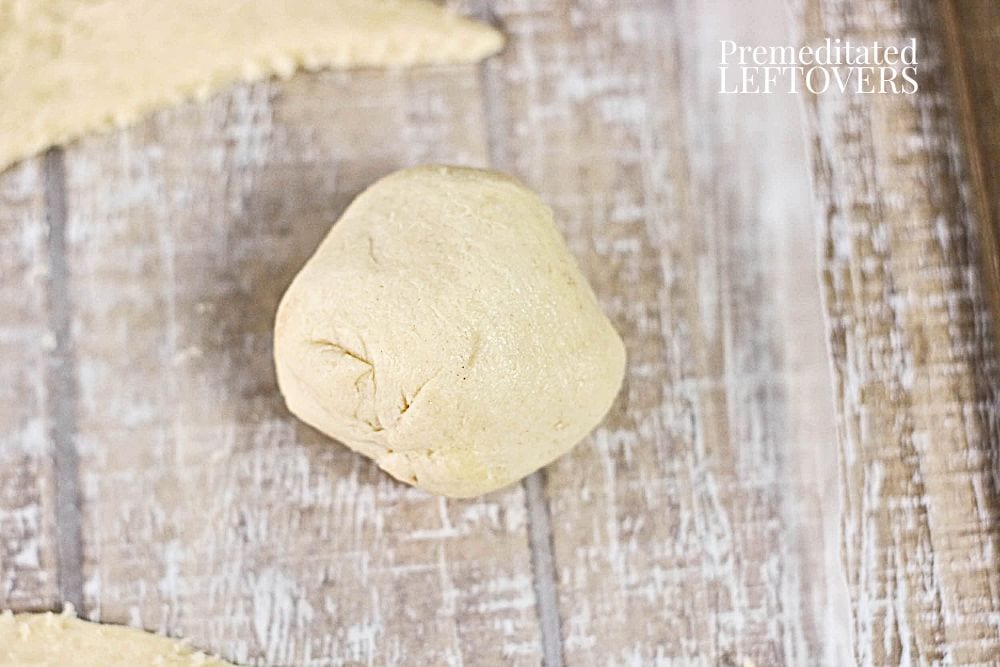 Finish wrapping the dough around the marshmallow and form into a ball.